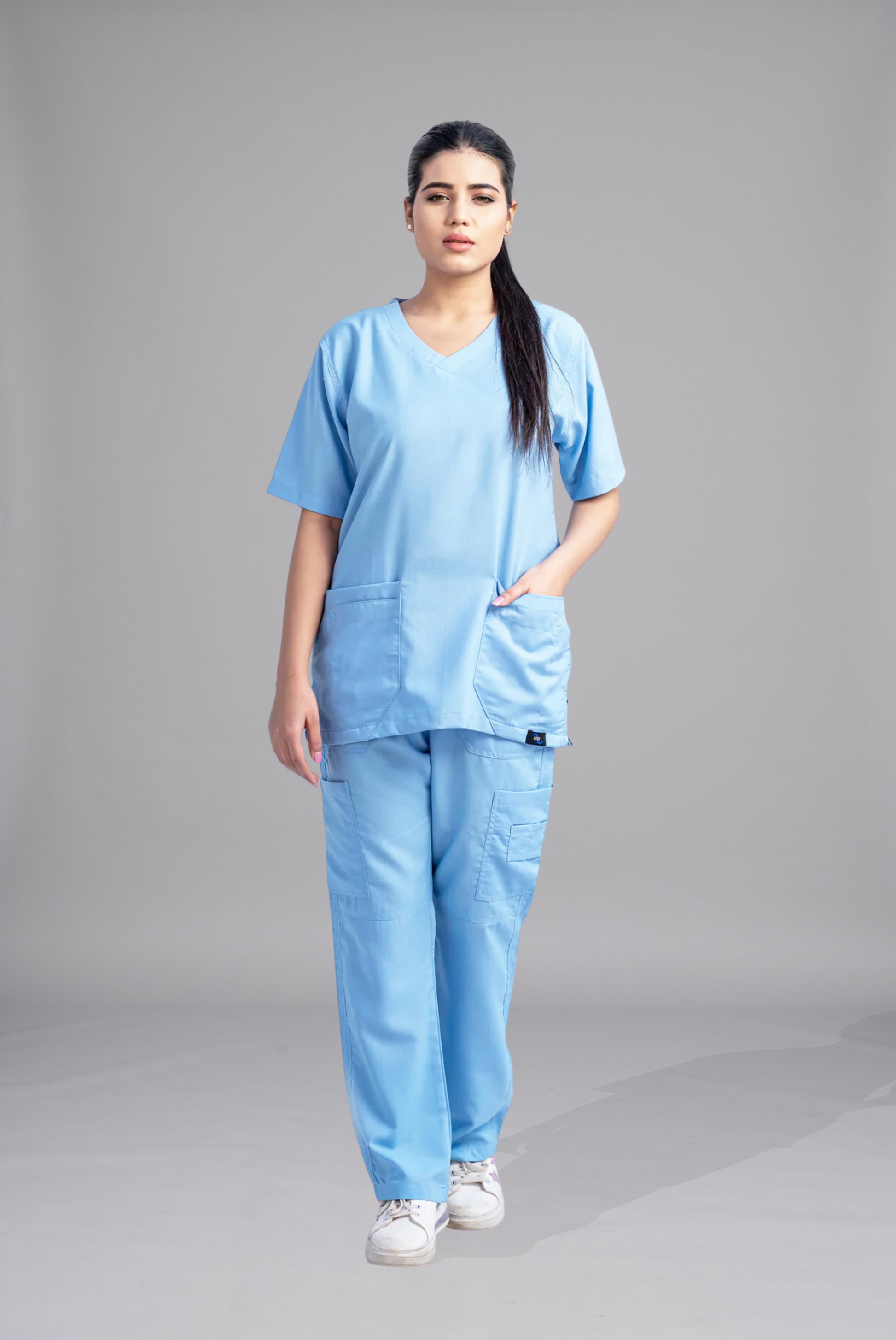 Classic Curve™ dusk blue scrub for women by Gtex Apparels in Pakistan, designed for practical healthcare work environments 1