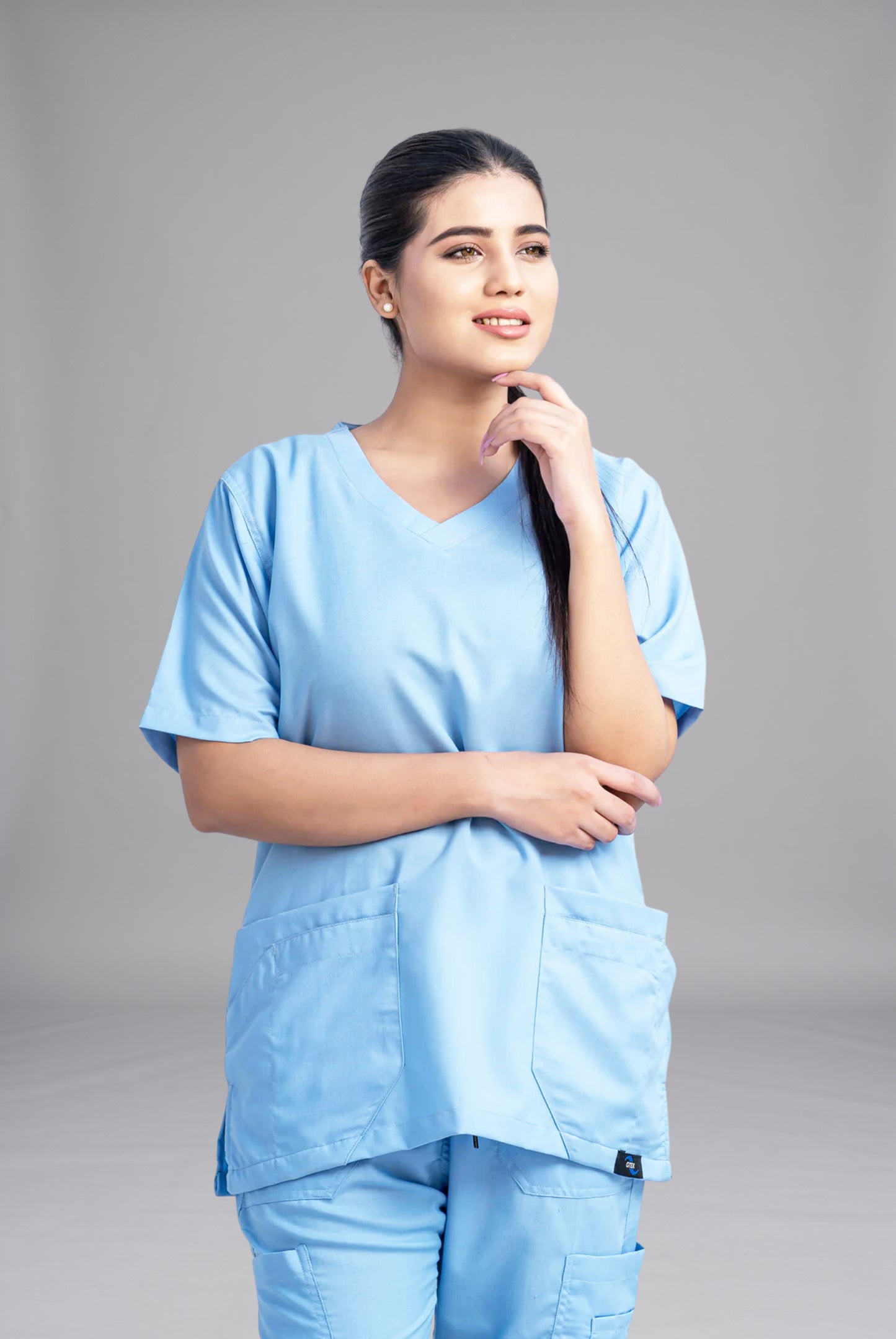 Classic Curve™ dusk blue scrub for women by Gtex Apparels in Pakistan, designed for practical healthcare work environments 1